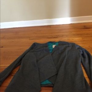 A gray and teal soft cardigan.